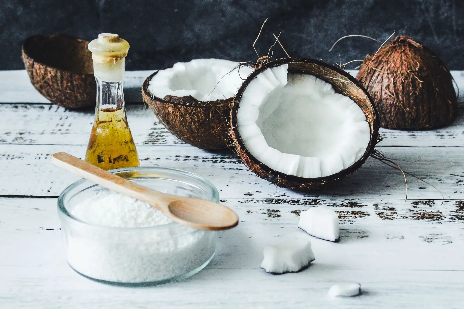 Unsweetened coconut flakes and coconut oil in small bowls