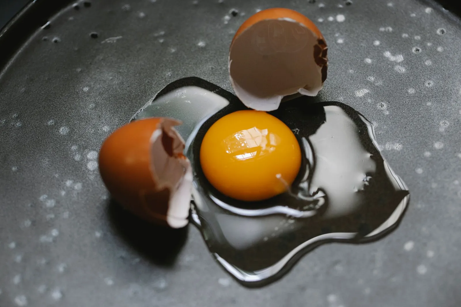 Raw cracked egg showing yolk and white