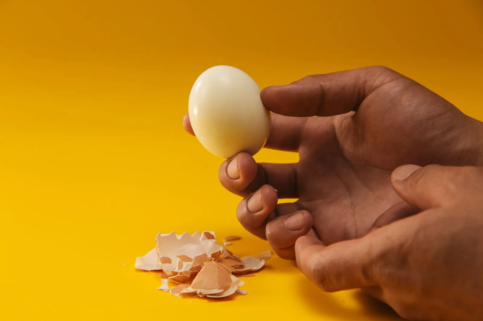 Peeled hard-boiled egg showing white and yolk