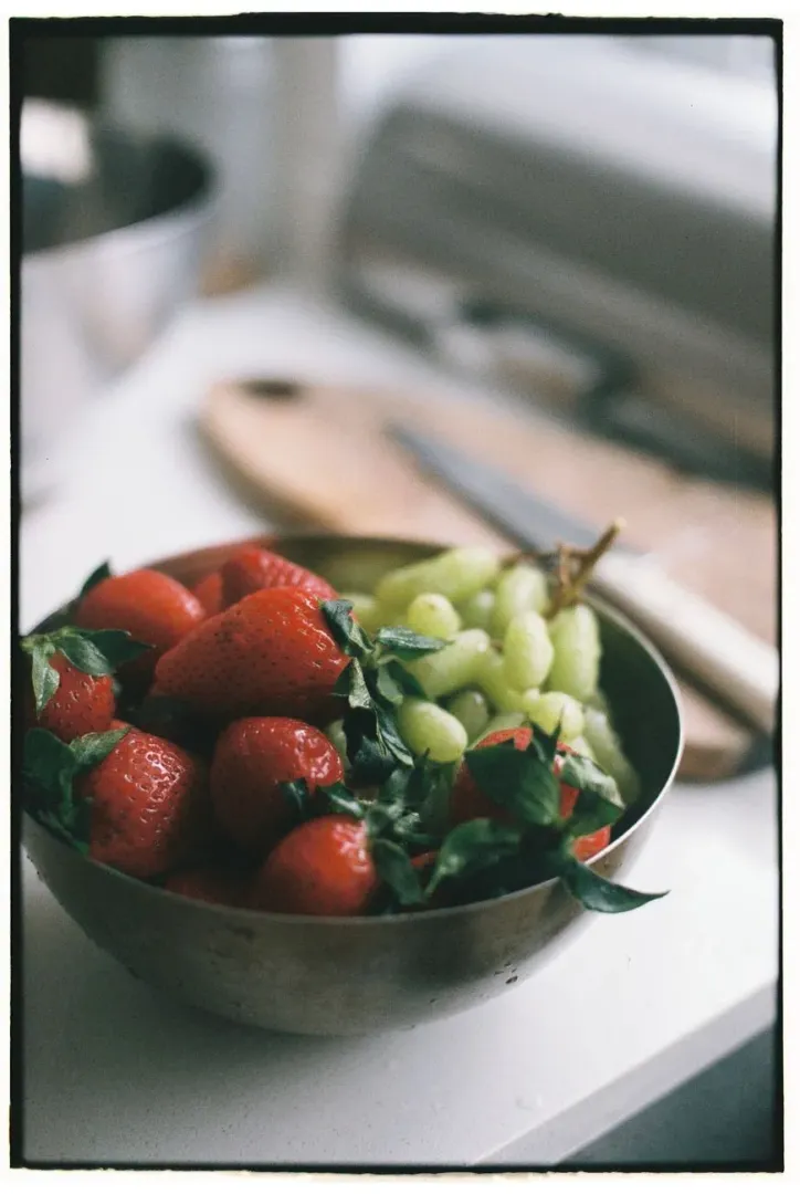 Grapes and fruit left on a kitchen counter