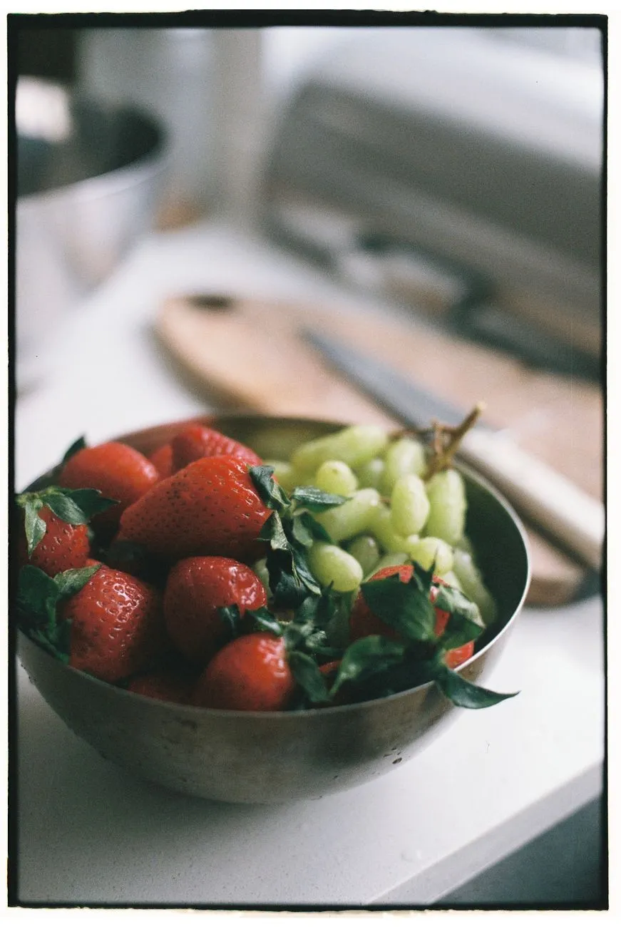 Grapes and fruit left on a kitchen counter