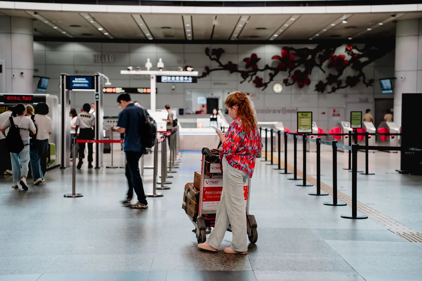 Traveller with luggage in a modern airport terminal