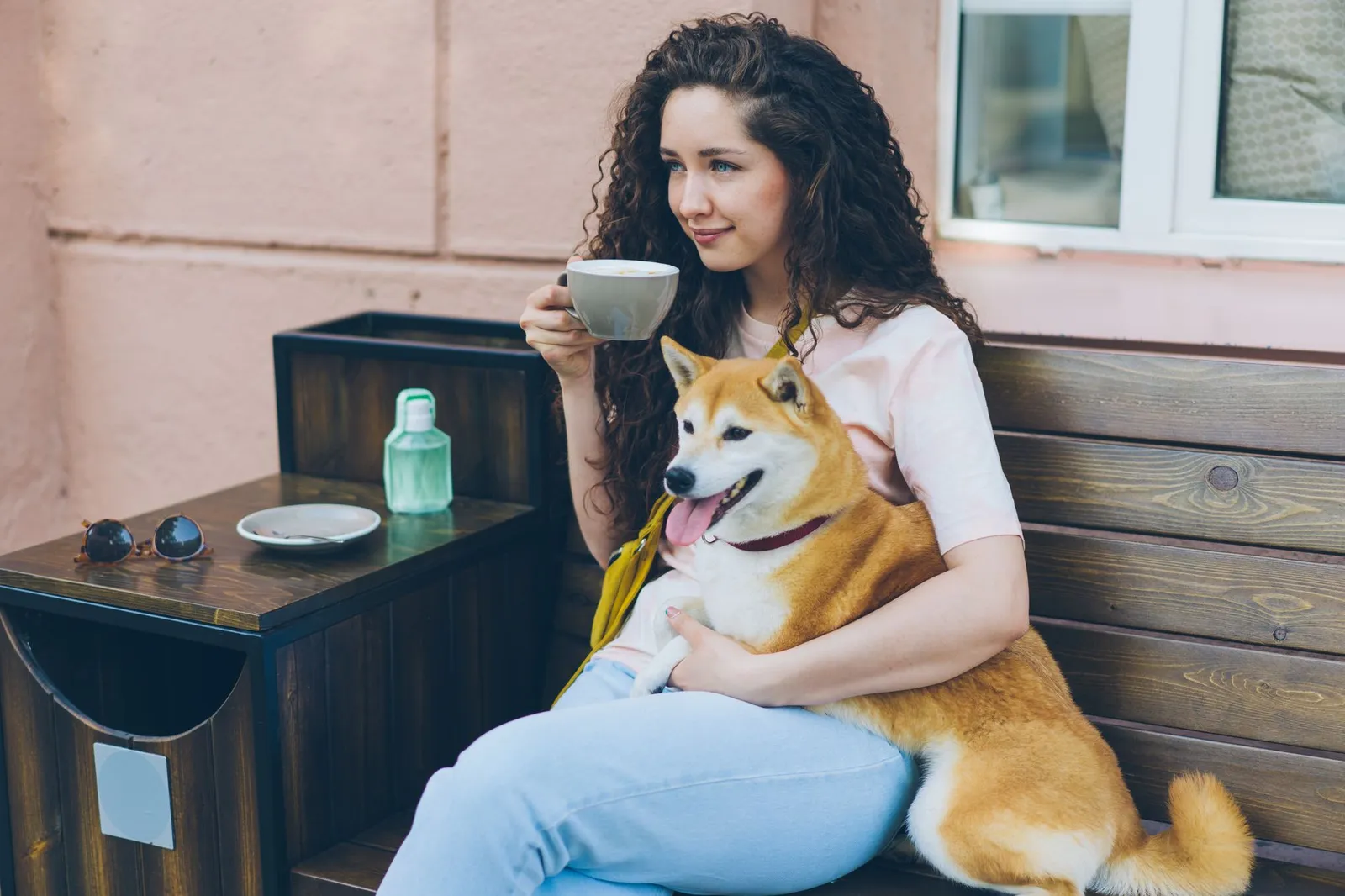 Person sitting outdoors with a coffee cup