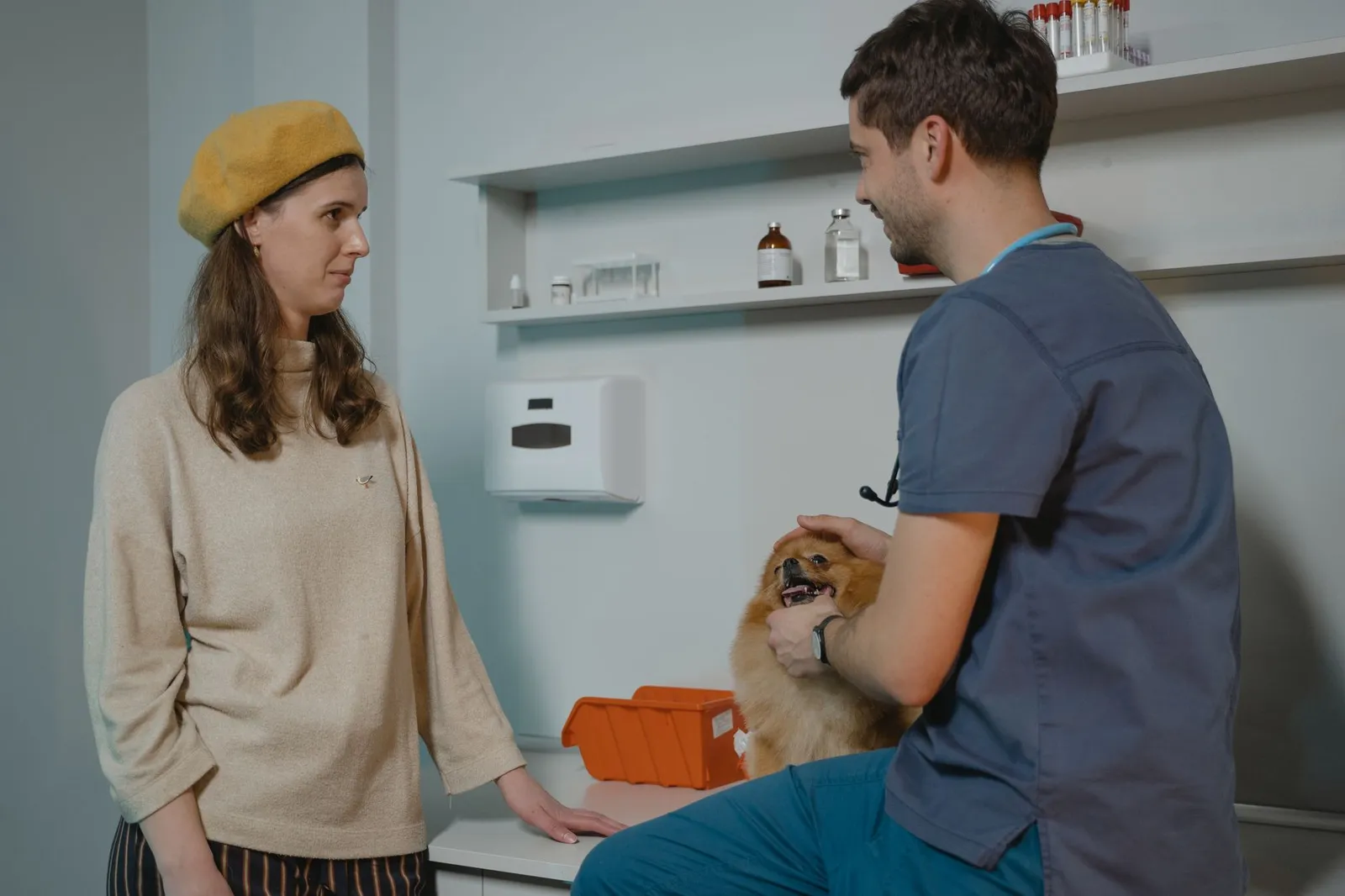 Dog parent at a veterinary clinic with a sick dog