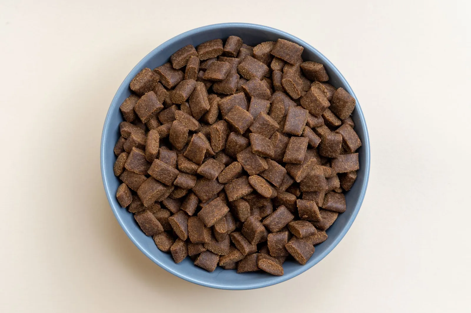 Person checking the ingredient list on a pet food package
