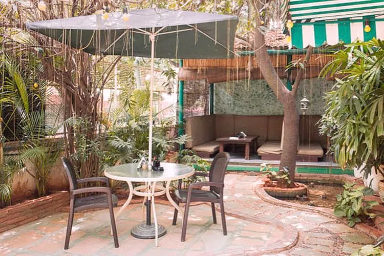 Empty outdoor patio seating with umbrella table at Green Theory
