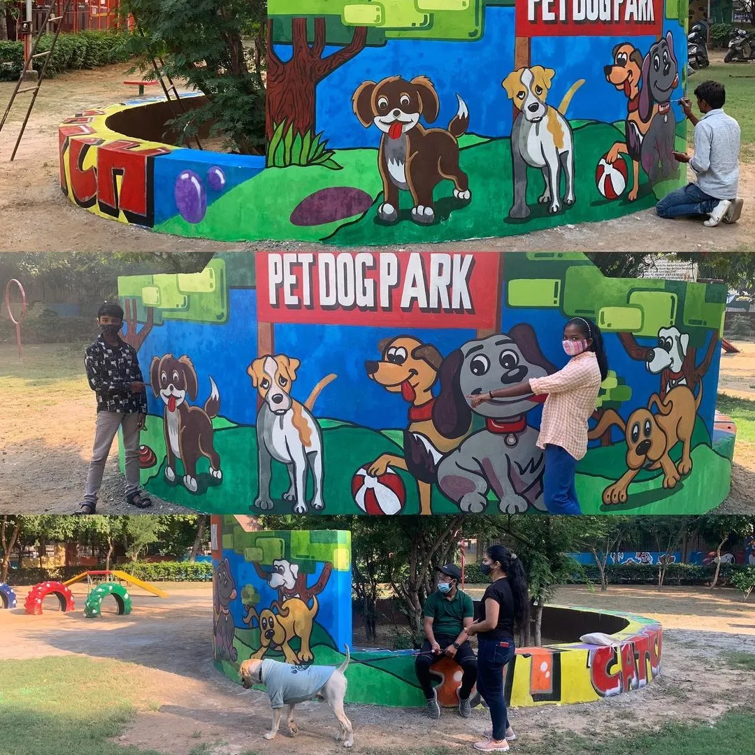 Colourful Pet Dog Park mural wall with a dog wearing a t-shirt nearby