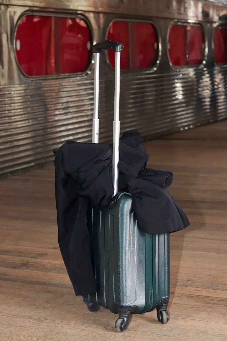 Hard suitcase standing on a railway platform