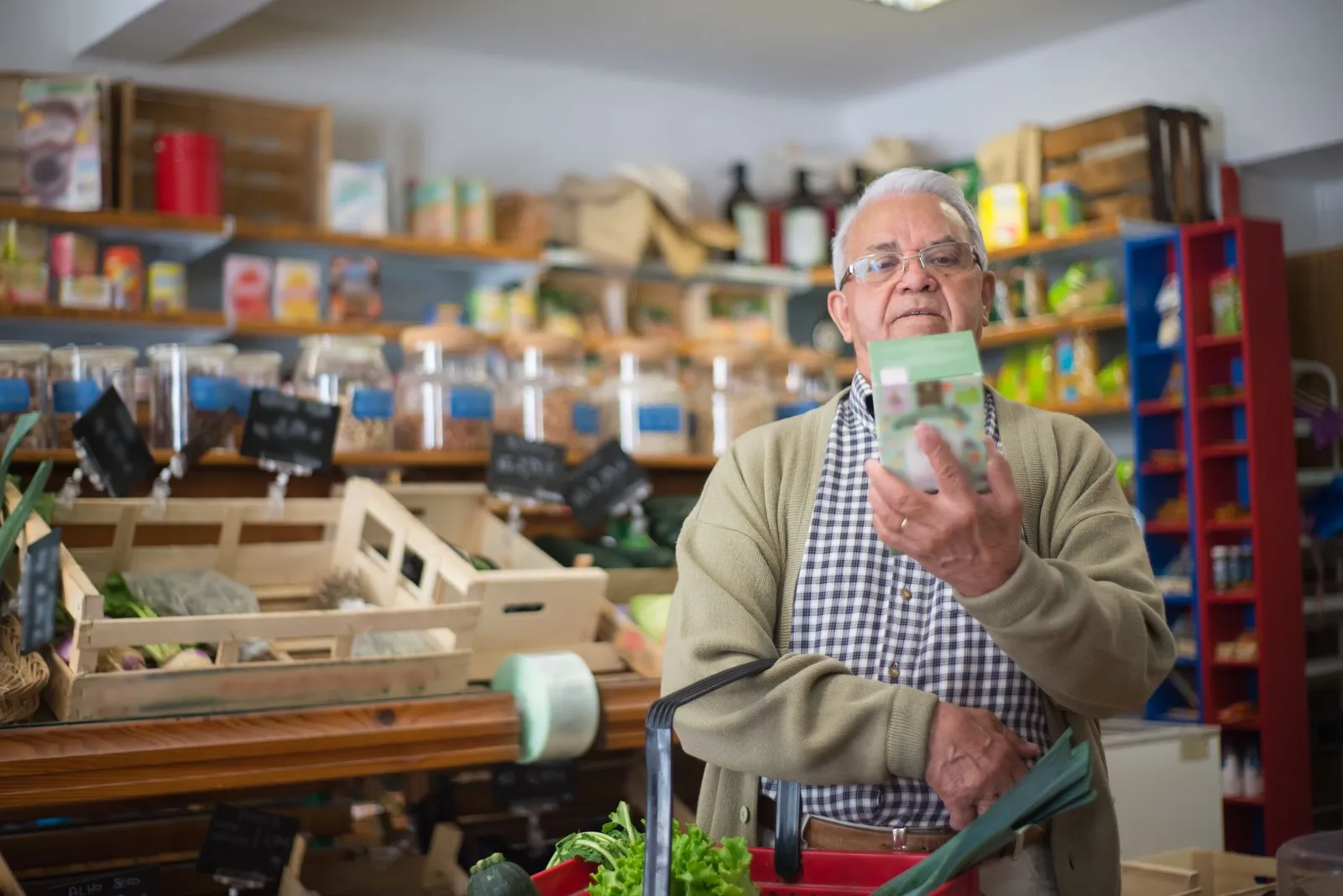 Person reading the ingredient label on a packaged food product
